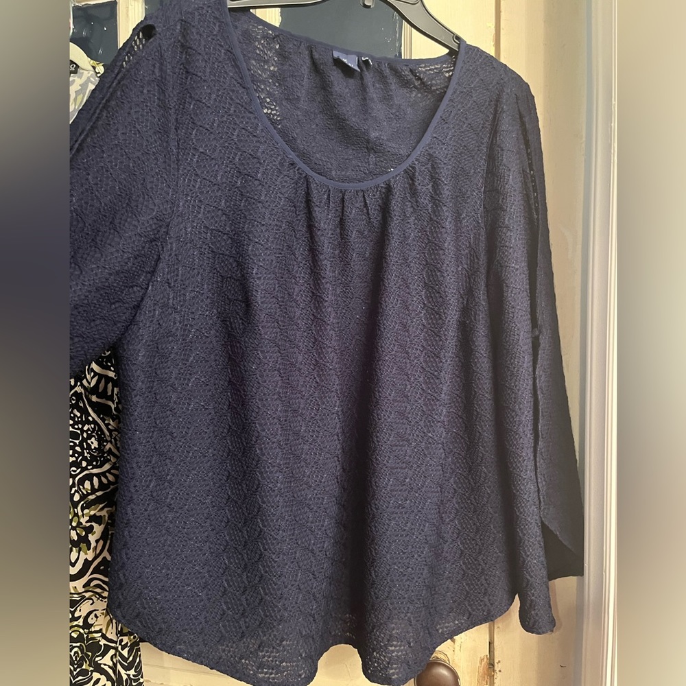 Blue tunic with split sleeve design.